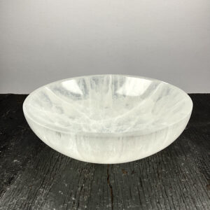 One Round Bowl (Large) - Selenite from the side - slightly translucent white bowls - on a dark wooden board