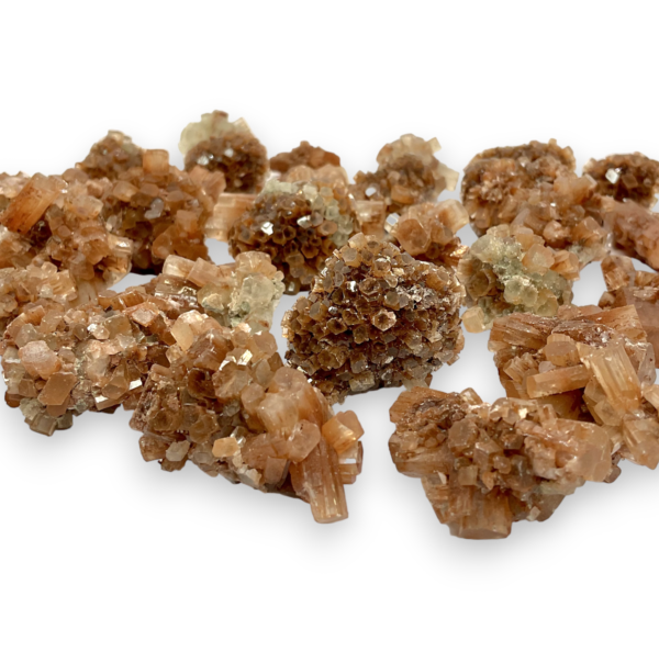 Large selection of Rough Brown Aragonite - red/brown star clusters of hexagonal tubes - on a white background.