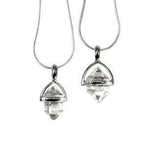 Two Herkimer A+ Pendant - clear stone with points at both ends, hanging from a silver bail - on a white background