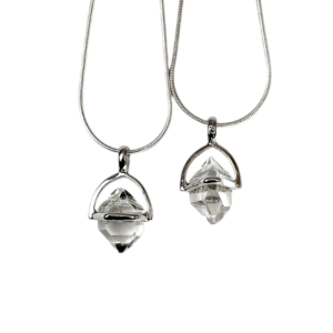 Two Herkimer A++ Pendant - clear stone with points at both ends, hanging from a silver bail - on a white background