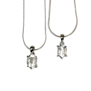 Two Herkimer AAA Pendant - clear stone with points at both ends, hanging from a silver bail - on a white background
