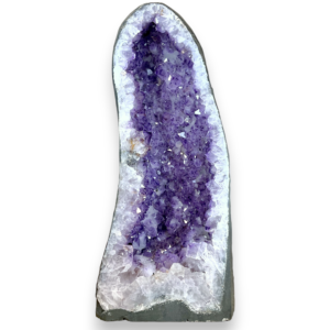 Amethyst Cave (3) shown from the front - half of a giant geode with purple points - on a white background