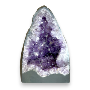 Amethyst Cave (4) shown from the front - half of a giant geode with purple points - on a white background