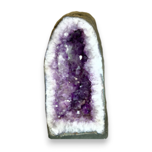 Amethyst Cave (5) shown from the front - half of a giant geode with purple points - on a white background