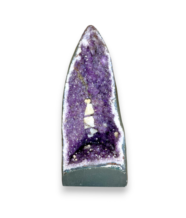Amethyst Cave (6) shown from the front - half of a giant geode with purple points - on a white background