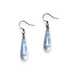 One pair of Blue Lace Agate Pear Drop Earrings - elongated banded pale blue teardrop stones with sterling silver hooks - on a white background