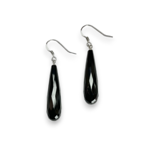 One pair of Black Agate Faceted Pear Earrings - elongated black faceted teardrop stones with sterling silver hooks - on a white background