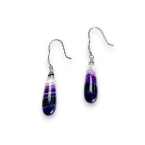 One pair of Fluorite Pear Drop Earrings - elongated banded purple and clear teardrop stones with sterling silver hooks - on a white background