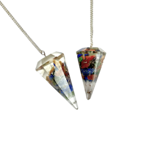 Example of two Orgone Pendulums - purple, dark blue, blue, green, yellow, orange and red chips in a transparent casing - on a silver chain, on a white background