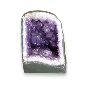 Amethyst Cave (10) shown from the front - half of a giant geode with purple points - on a white background