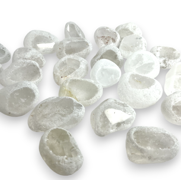 Group of Dragon Egg - Quartz - transparent partially tumbled stones, with a white, rough texture, and one polished face revealing the colour of the stone inside - on a white background