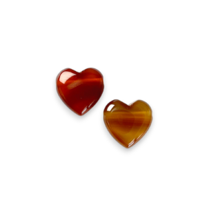 Two Carnelian Heart Side-Drilled side by side - red and orange stone in the shape of a heart - on a white background