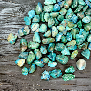 Example of Chrysocolla Green (A Grade) tumble stone - deep green and blue stone - on a black background