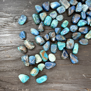 Example of Chrysocolla Shattuckite tumble stone - deep green and blue stone - on a black background