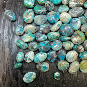 Example of Chrysocolla with Quartz tumble stone - deep green and blue stone white/clear crystal throughout - on a black background