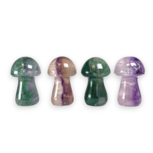 Four Fluorite Mushrooms in a row - translucent green, purple and clear stone - on a white background