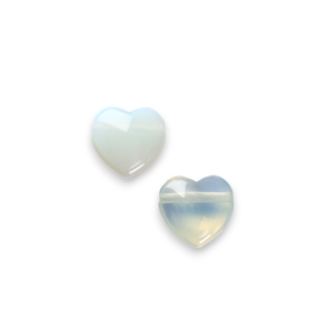 Two Opalite Heart Side-Drilled side by side - translucent pale blue stone - on a white background