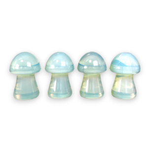 Four Opalite Mushrooms in a row - blue glass - on a white background