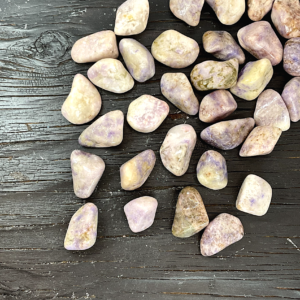 Example of Prairie Tanzanite tumble stone - pale pink with soft touches of purple and beige - on a black background