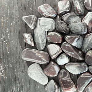 Example of Ancestralite A Grade tumble stone - Beautiful shades of metallic silver, black and garnet red